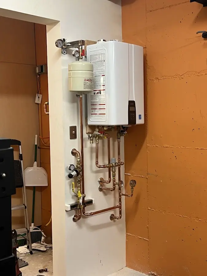 Plumbing technician inspecting water heater connections in Vernon Hills